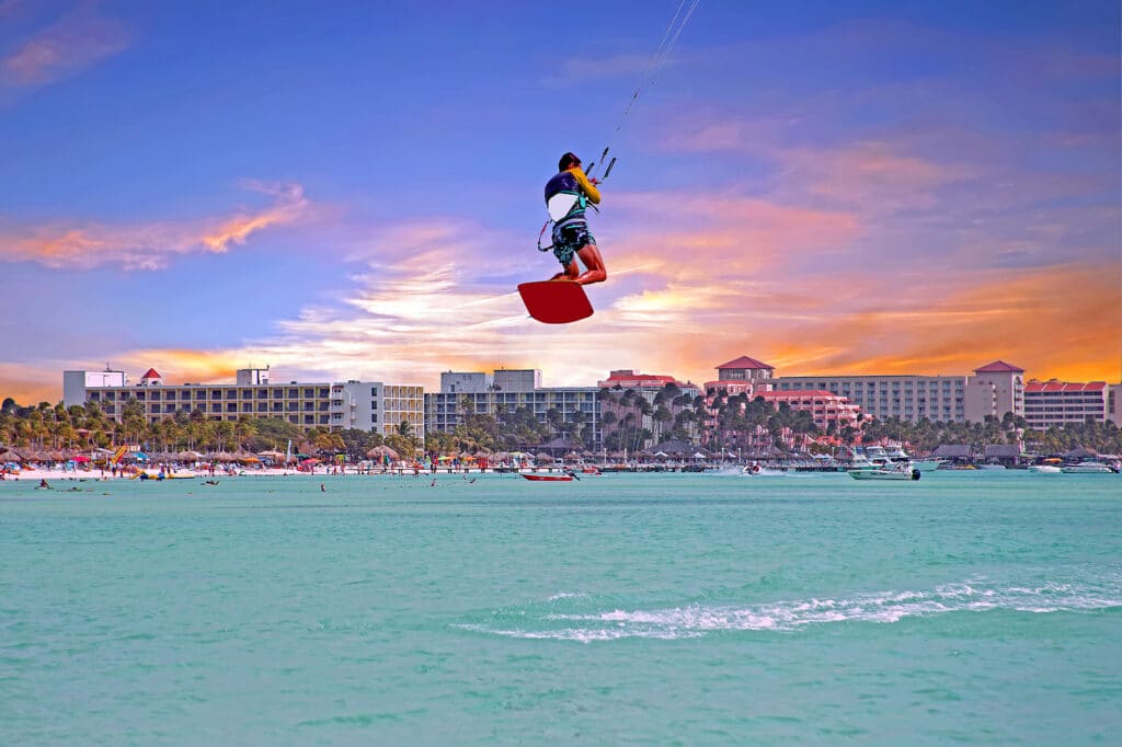 Kite surfer at Palm Beach on Aruba island at sunset