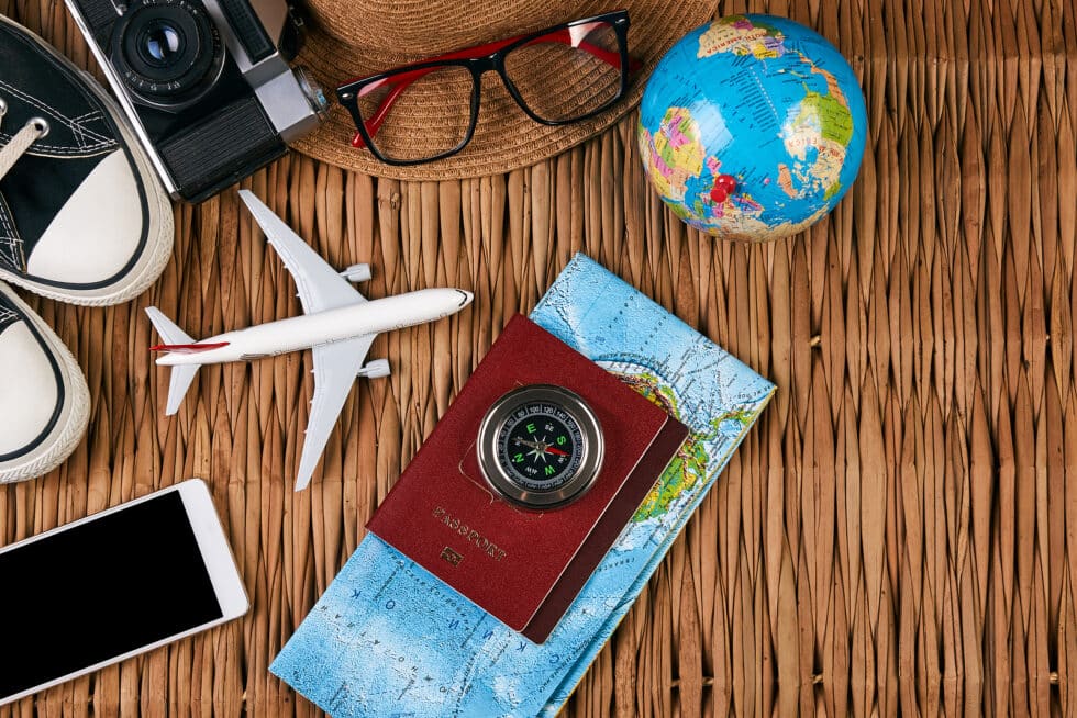 Resort Concierge Escapes shows a passport, map, phone, and travel accessories used when preparing for an international journey.